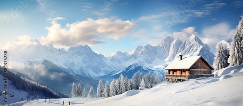 Alpine cabin and wintry scenery.