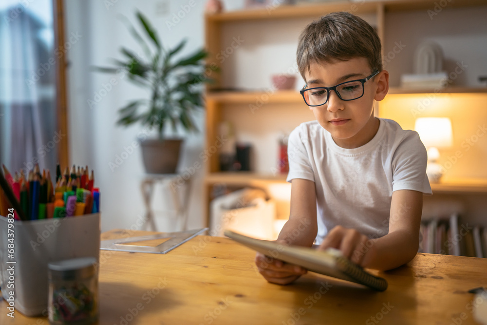 young boy child kid pupil study work on homework assignment at home