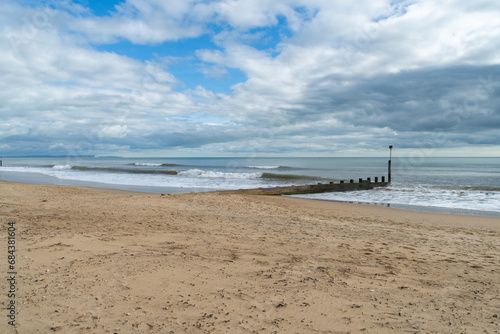 Bournemouth, UK - March 26th 2023: Waves alongside a groyne on Bournemouth Beach.