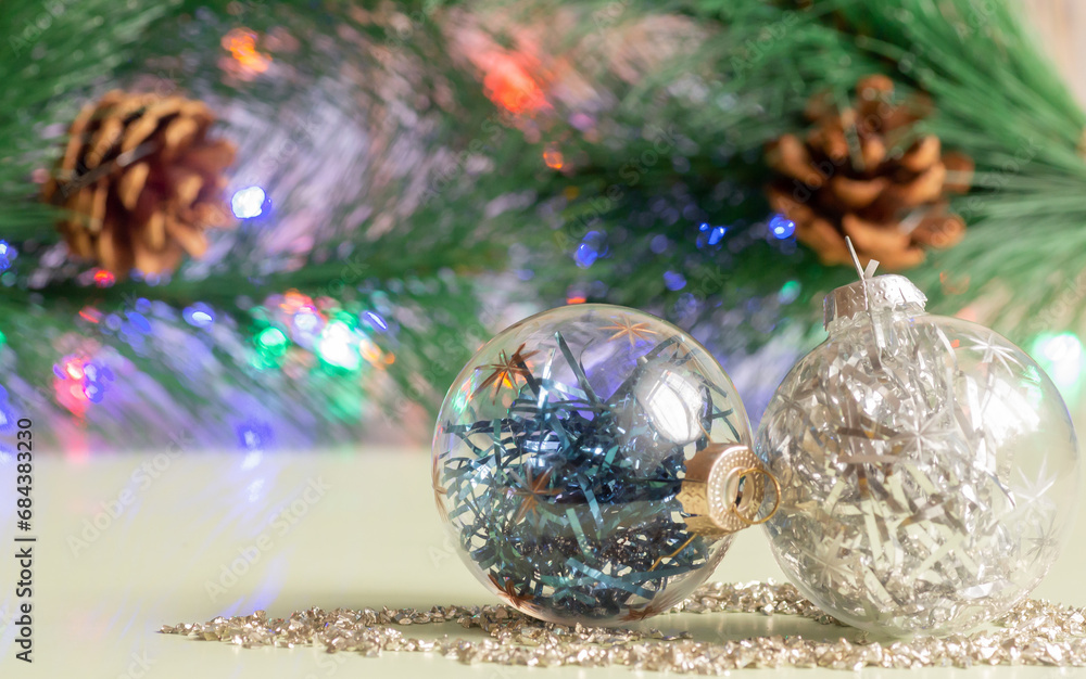 New Year's balls in close-up on the background of a Christmas tree branch with cones New Year's balls in close-up on the background of a Christmas tree branch with cones