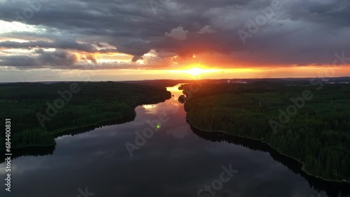 Drone shot rising over a mirroring island narrows, beautiful evening in Finland photo