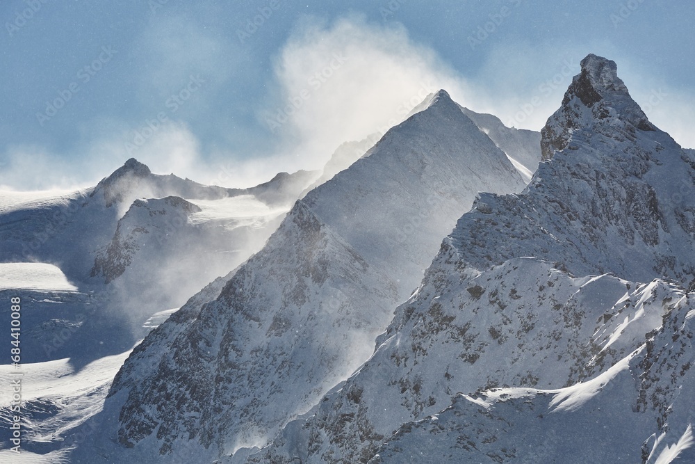 Obraz premium Winter high mountains in clouds, snowing