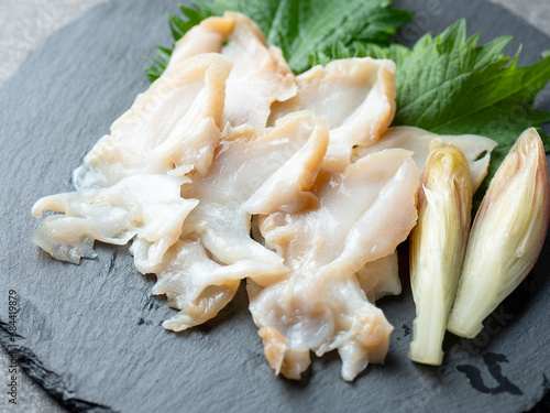 Whelk sashimi on a stone plate