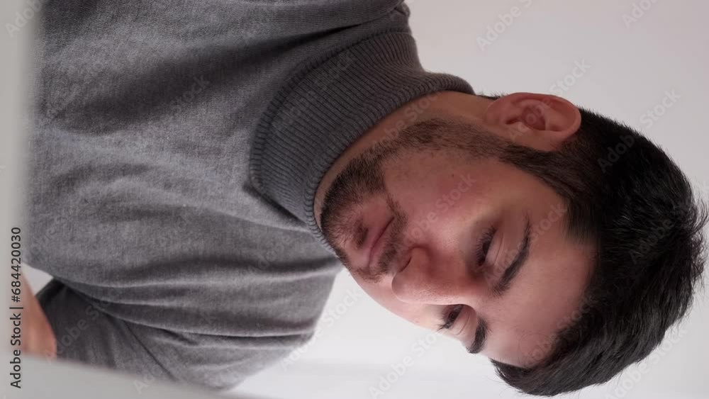 Vertical video. Tired employee. Work deadline. Overwork fatigue. Sleepy exhausted stressed business man workaholic upset with job burnout at laptop. Vertical video. Tired employee. Work deadline. Overwork fatigue. Sleepy exhausted stressed business man workaholic upset with job burnout at laptop.