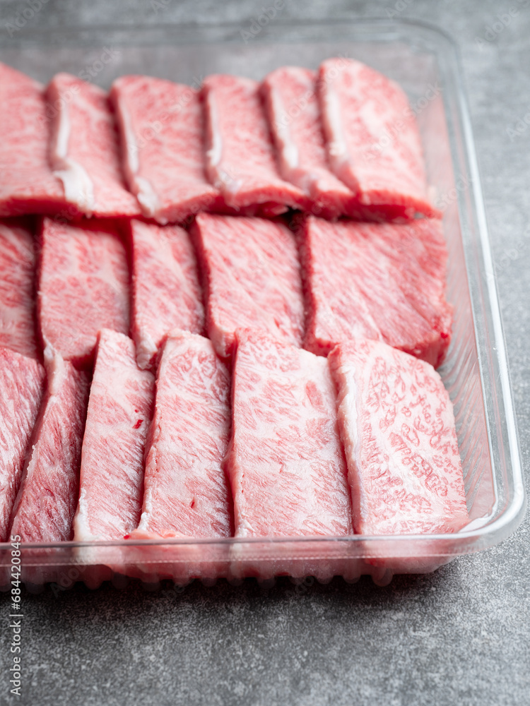 Fresh raw meat in a plastic container
