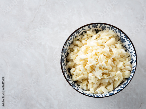 chopped garlic in bowl photo