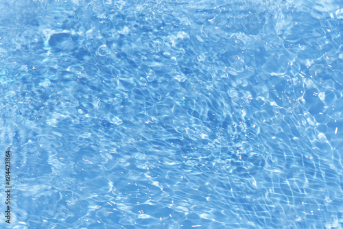 Bluewater bubbles on the surface ripples. Defocus blurred transparent white-black colored clear calm water surface texture with splash and bubbles. Water waves with shining pattern texture background.