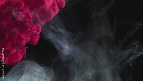 Pink Fluid Billowing into Solution with Smoky Effect photo