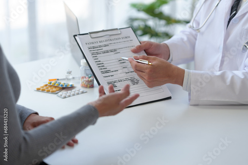 Medical service worker or doctor, pharmacist talking about medical test results at table in clinic Giving advice on how to take medicine to female patients, explaining prescriptions. Health care. photo