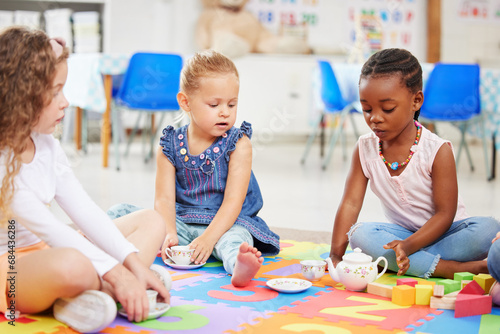 Kids  tea party and playing for fun in school with friends  together and bonding. Diversity  little girls and face with toy on mat for child development  motor skills and growth for future in daycare