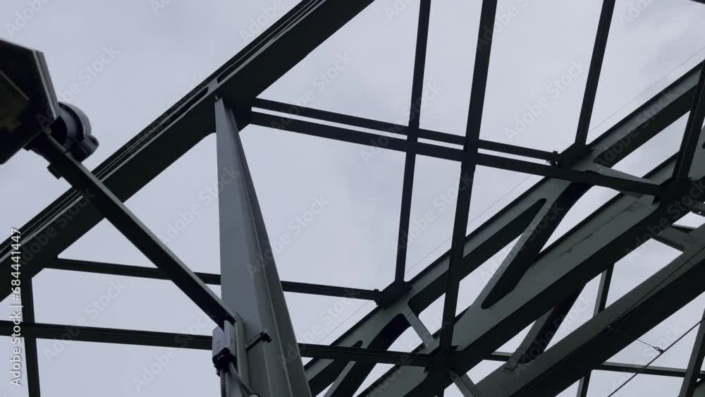Steel supports and struts of a metal device with an old lantern of the Hohenzollern Bridge in Cologne Steel supports and struts of a metal device with an old lantern of the Hohenzollern Bridge in Cologne