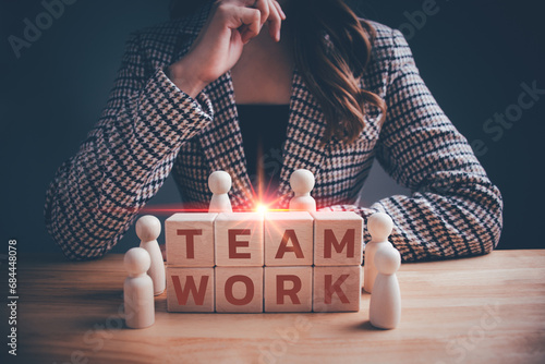 "TEAMWORK" text on wooden cube blocks and people symbol. Human resource management, Team, teamwork, leadership, brainstorming, corporation, smart teamwork for business organization concepts.
