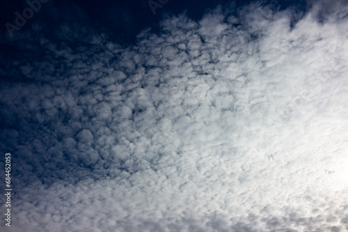 Blue sky covered with dense altocumulus clouds photo