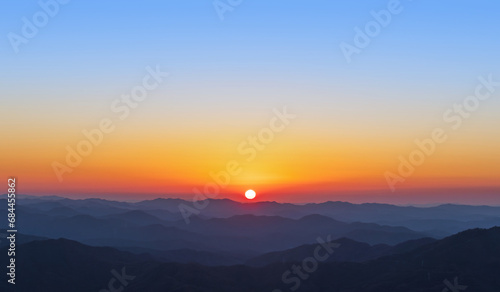 A view of the sun setting over the mountains. sunset © two K
