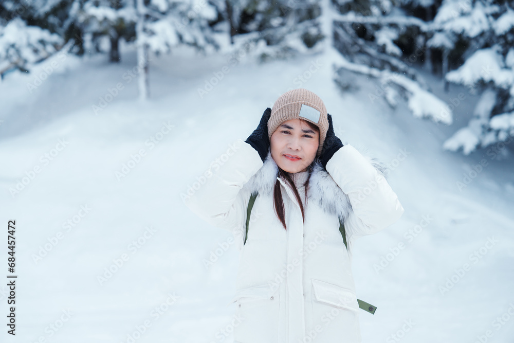 happy Traveler with Sweater and backpack walking on snow covered forest in frosty weather. Winter Travel, Adventure, Exploring and Vacation concept happy Traveler with Sweater and backpack walking on snow covered forest in frosty weather. Winter Travel, Adventure, Exploring and Vacation concept