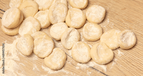 Dough for dumplings on a wooden table