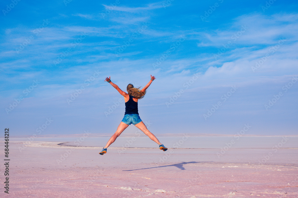 Happy woman jumping on salt beach- Golu tuz, Turkey Happy woman jumping on salt beach- Golu tuz, Turkey