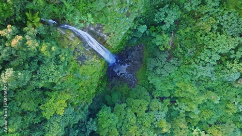 Aerial top down shot of rainforest with falling waterfall in Bonao, Dominican Republic photo