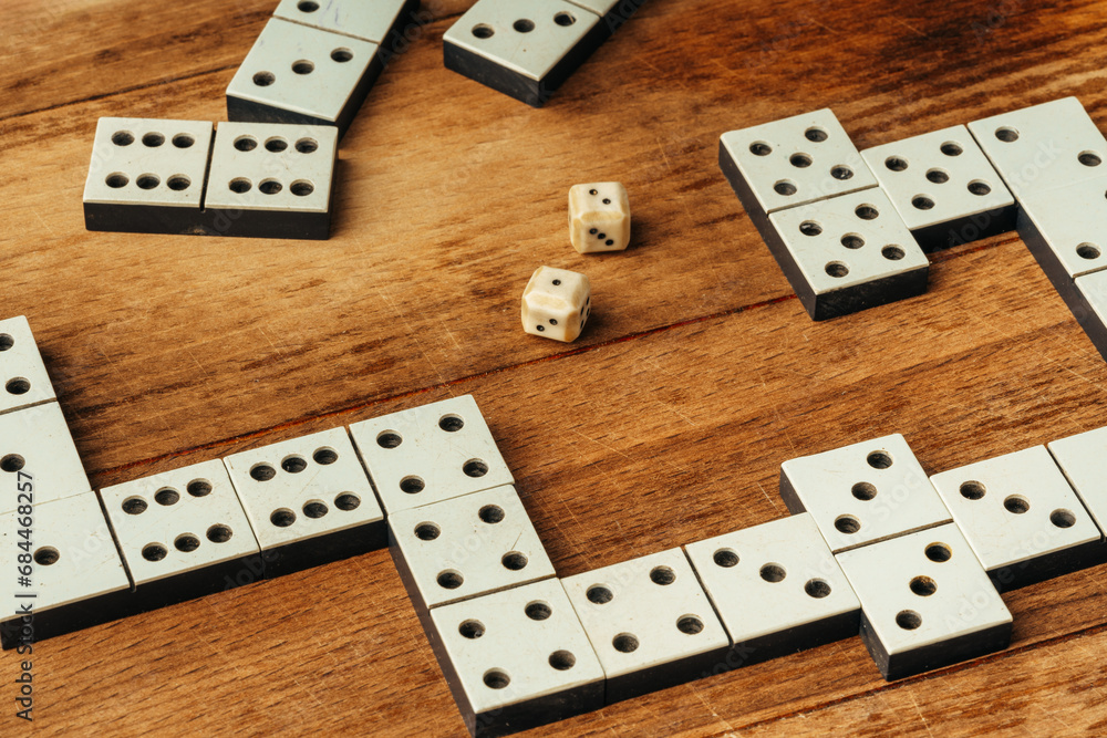 Domino game on brown wooden background close up Domino game on brown wooden background close up