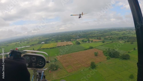 POV of ultralight plane gliding across down to the ricefield photo