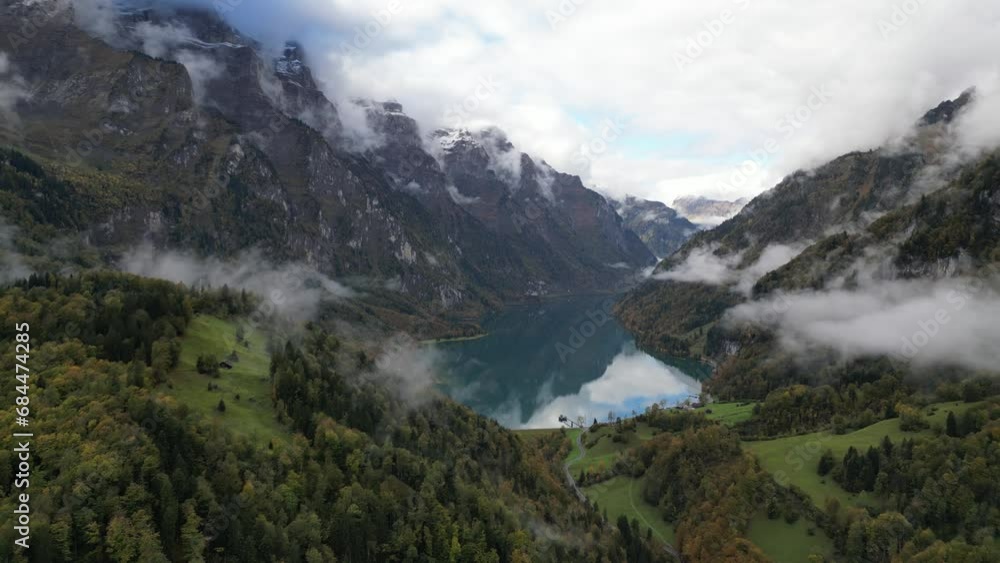 Panoramic aerial shot of high mountains and lake situated in the valley Klöntalersee Glarus Switzerland Panoramic aerial shot of high mountains and lake situated in the valley Klöntalersee Glarus Switzerland