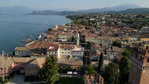 Left to right aerial pan shot of a city near sea with antique architecture Lazise gardasee verona photo
