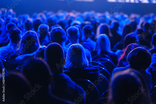 From above back view of businesspeople attending concert in stadium