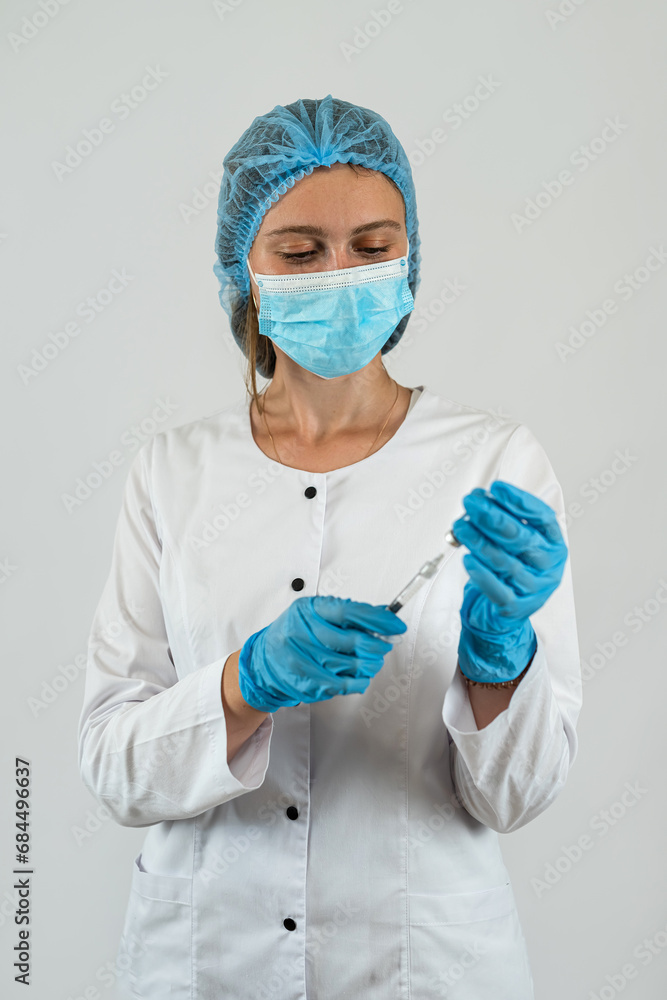 Female doctor in a mask gloves hold syringe with vaccine isolated on white. Female doctor in a mask gloves hold syringe with vaccine isolated on white.