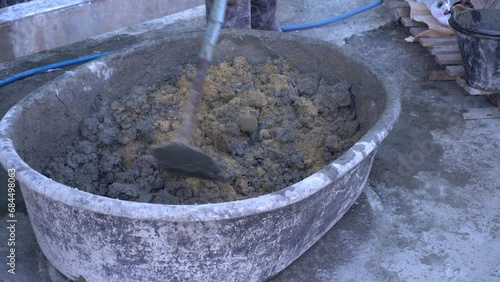 Mixing a cement in salter for applying construction photo