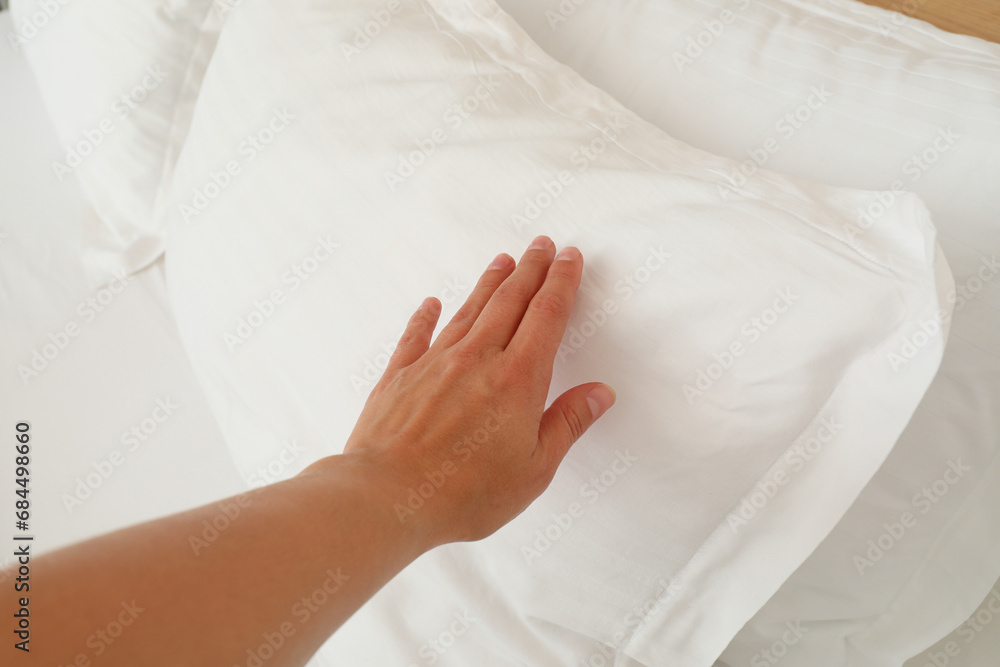 A soft, white pillow on the bed A soft, white pillow on the bed
