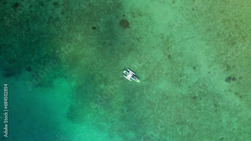 ドローンで真上から空撮した奄美大島に浮かぶ小舟（Amami Oshima Island） photo