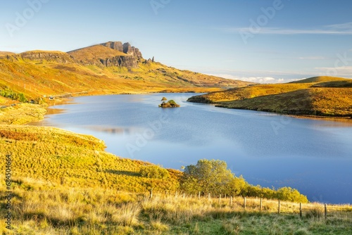 View of rock needle Old Man of Storr  loch with small island in foreground  Isle of Skye  Inner Hebrides  Scotland  United Kingdom  Europe