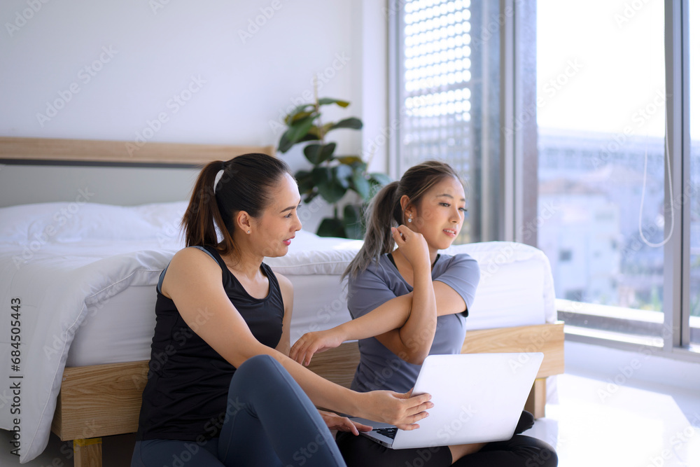 Two women play yoga at home. Two women play yoga at home.