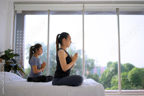 Two women play yoga at home. Free Download Two women play yoga at home. - GFXLoad