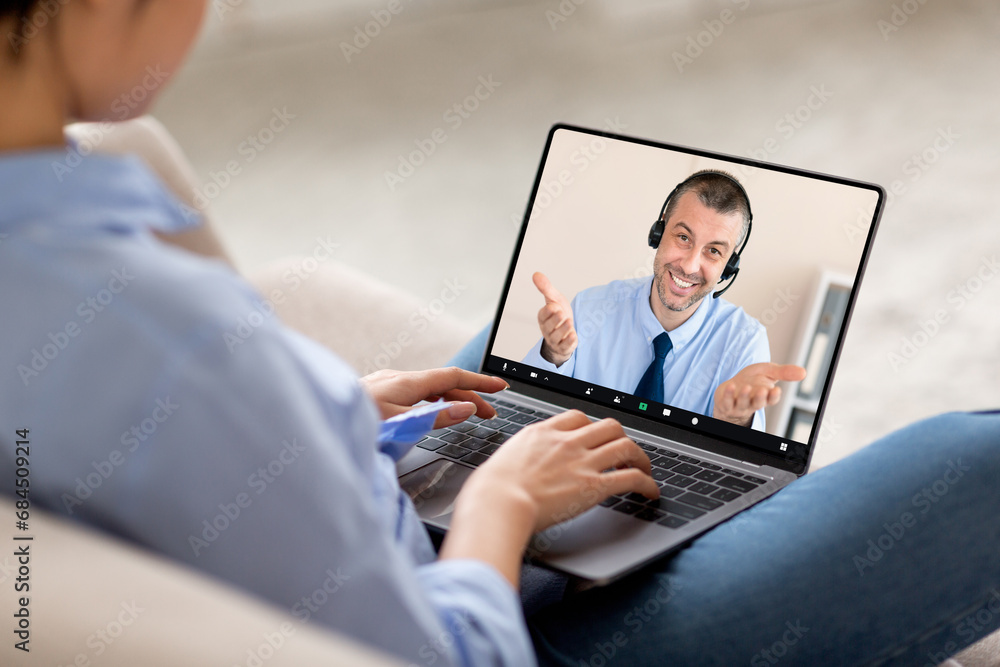 Over shoulder shot of woman using laptop, video chat Over shoulder shot of woman using laptop, video chat