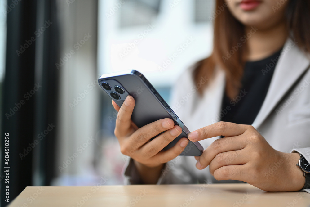 Select focus on businesswoman texting messages, communicating in social network on mobile phone Select focus on businesswoman texting messages, communicating in social network on mobile phone
