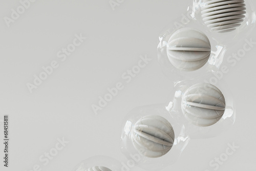 3D render of row of plastic wrapped spheres floating against white background photo