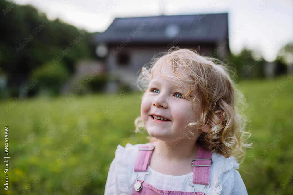 Cute little girl in front her family house Cute little girl in front her family house