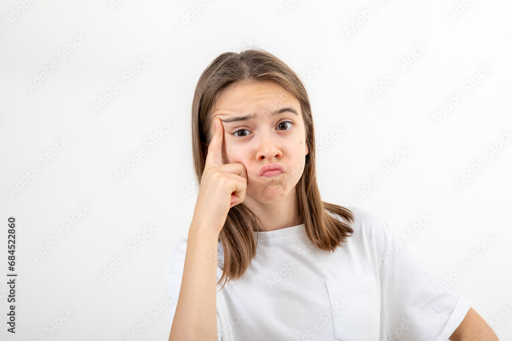 Little girl thinking, holding finger at temple, isolated on white background. Little girl thinking, holding finger at temple, isolated on white background.