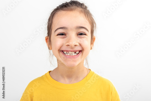 Happy little Caucasian girl smiling on white background isolated, close up.