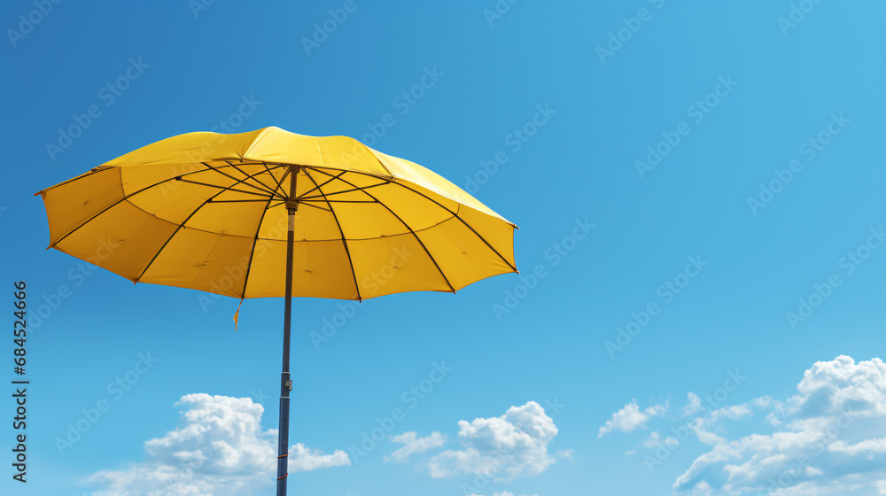 A yellow umbrella against a blue sky with a pole