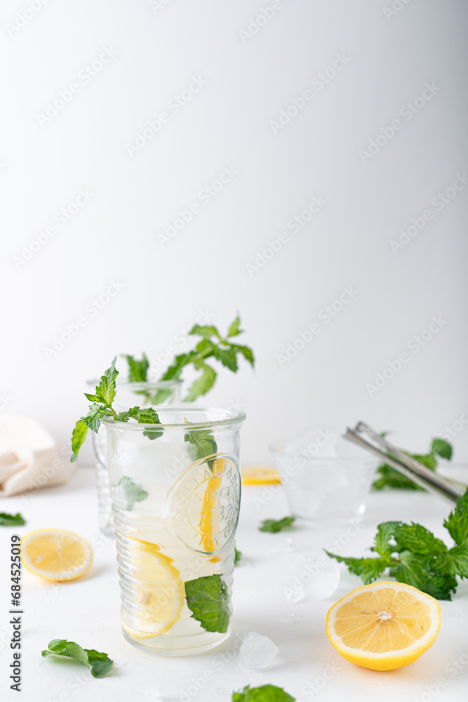 Lemonade with mint on a white background. Cool drink with lemon and mint. Lemonade with mint on a white background. Cool drink with lemon and mint.