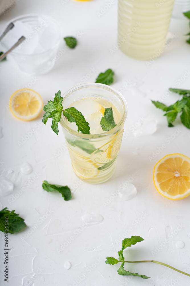 Lemonade with mint on a white background. Cool drink with lemon and mint. Lemonade with mint on a white background. Cool drink with lemon and mint.