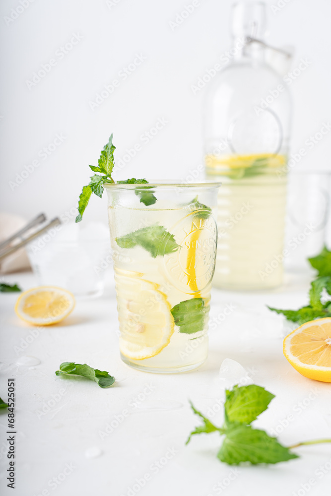Lemonade with mint on a white background. Cool drink with lemon and mint. Lemonade with mint on a white background. Cool drink with lemon and mint.