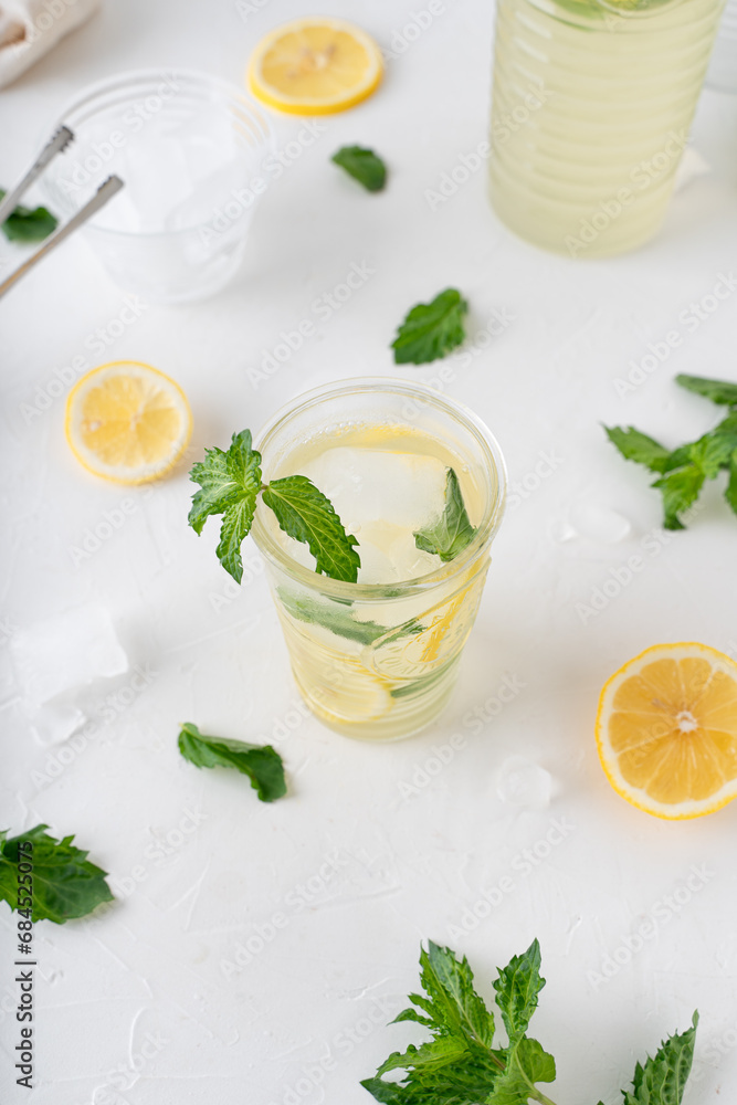 Lemonade with mint on a white background. Cool drink with lemon and mint. Lemonade with mint on a white background. Cool drink with lemon and mint.