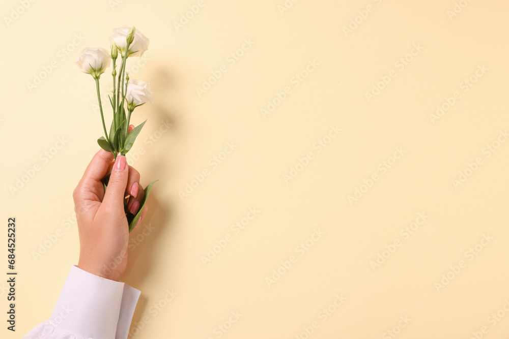 Woman with eustoma flowers on beige background, top view. Space for text Woman with eustoma flowers on beige background, top view. Space for text