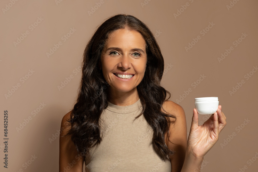 Cheerful caucasian senior lady show jar of cream, enjoy beauty care Cheerful caucasian senior lady show jar of cream, enjoy beauty care