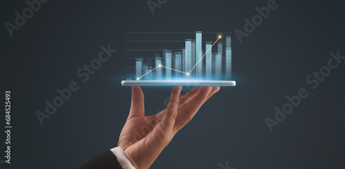 Businessman plan graph growth and increase of chart positive indicators,tablet in hand