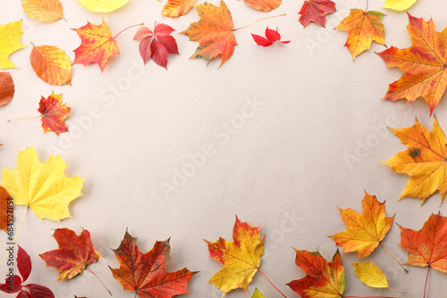 Autumn season. Frame of colorful maple leaves on light grey background, flat lay with space for text