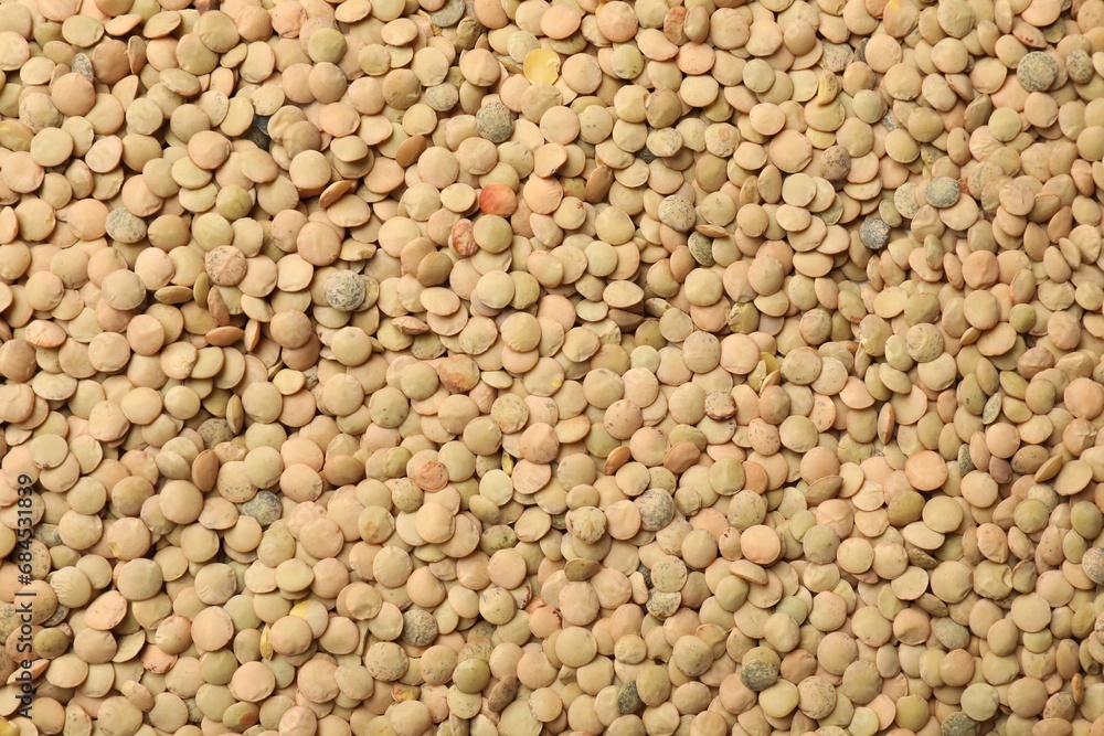 Fototapeta premium Many raw lentils as background, top view